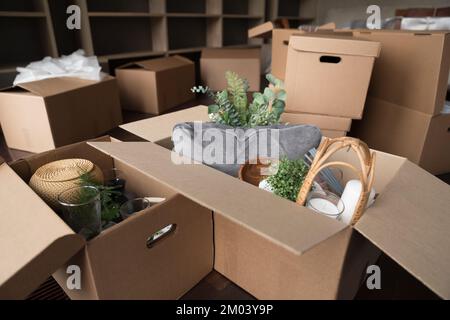 Open cardboard logistic boxes with housing stuff close up Stock Photo