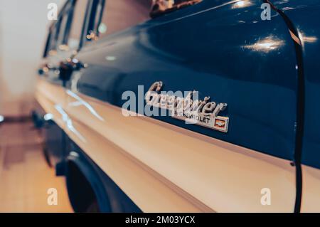 "7/31/2021 - Sharjah, UAE: 1962 Chevrolet (Chevy) Greenbrier American van with side logo to blurred defocused background" Stock Photo