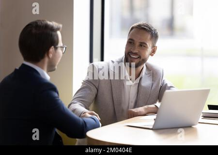Two business partners finish successful negotiations with shake hands Stock Photo
