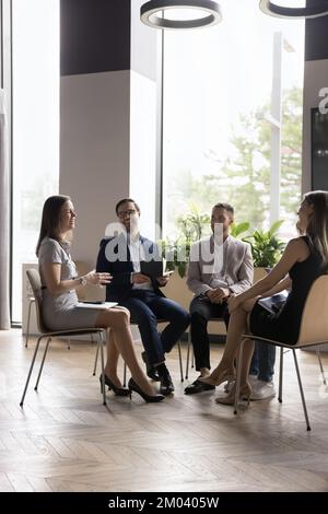 Group of smiling positive employees engaged in teambuilding event Stock Photo