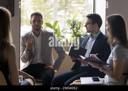 Group of office employees listen to boss at briefing Stock Photo
