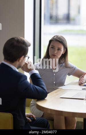 Two serious business partners met in office talking, discuss business Stock Photo