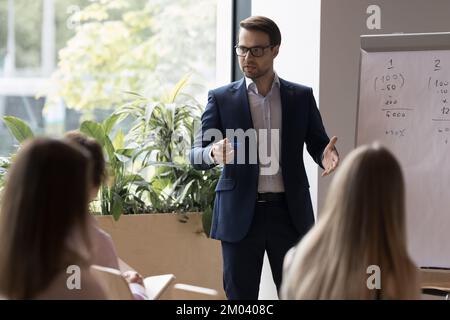 Business trainer makes speech during corporate training in office Stock Photo
