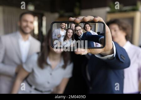 Close up on cellphone screen view of happy business people Stock Photo