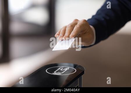 Closeup unrecognizable man hand using pass card enters in office Stock Photo
