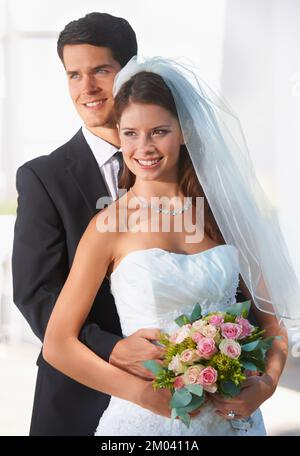 Posing for photos. A lovely couple posing for photos at their wedding. Stock Photo