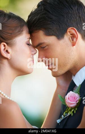 Sharing a tender moment. Intimate image of a newlywed couple basking in their love. Stock Photo