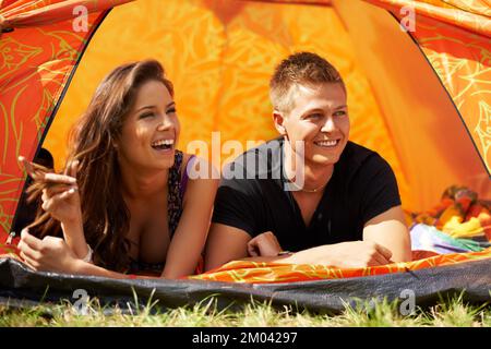 Camping couple. a young couple lying in a tent together. Stock Photo