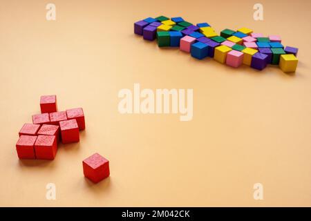 Affinity bias concept. Red cubes lie separately from other colors. Stock Photo