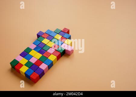 An arrow of multi-colored cubes as a symbol of unity, cooperation and teamwork. Stock Photo