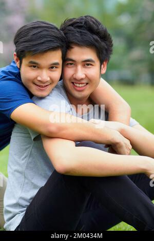 Enjoying a day together. Portrait of an affectionate young gay couple spending time together outdoors. Stock Photo