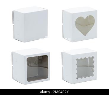 White cardboard boxes with clear plastic windows of different shape. Over white background. Placed on the side Stock Photo