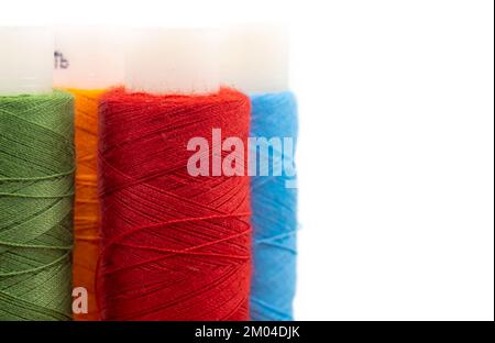 Spools of colored threads on a white background with an empty space for an inscription Stock Photo