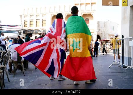 Fans with Union and Senegal flags in the Souq area of Doha, ahead of the FIFA World Cup Round of Sixteen match between England and Senegal which will be played at the Al-Bayt Stadium in Al Khor, Qatar. Picture date: Sunday December 4, 2022. Stock Photo