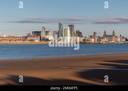 Wallasey, UK: Beach by the River Mersey, overlooked by Liverpool waterfront buildings. Stock Photo