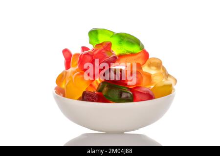 Several gummy bears in a white plate, macro, isolated on a white background. Stock Photo