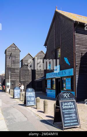 Hastings Old Town Fisheries on The Stade with traditional black painted tall net huts Hasting's Net Shops Hastings East Sussex England UK GB Europe Stock Photo