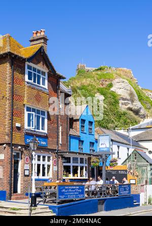 Hastings Old town with people sat outside the Dolphin Inn on Rock-a-nore road Hastings old Town Hastings East Sussex England UK GB Europe Stock Photo