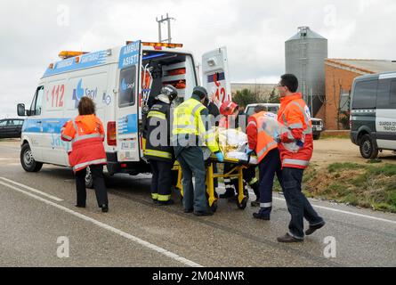 An ambulance is loaded with an injured person from a traffic accident by police, firefighters and paramedics. Stock Photo