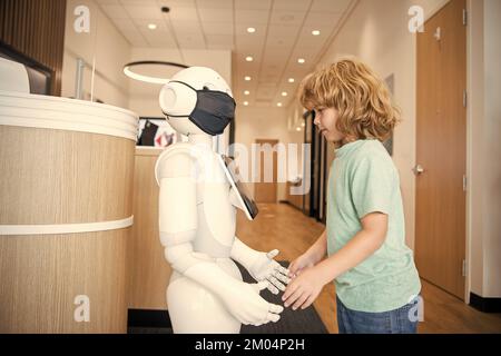 busy child interact with robot artificial intelligence, communication Stock Photo