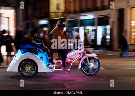 Rickshaw aka Pedicab at night on Regent Street in London. Stock Photo