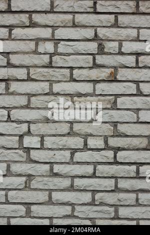 Typical common brick wall with layers of rectangular blocks. Stock Photo