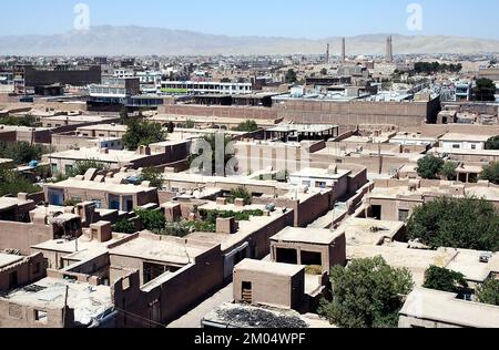 A view across the city of Herat in Afghanistan from Herat Citadel. The view shows the Musalla Minarets and Gawhar Shad Mausoleum in the distance. Stock Photo