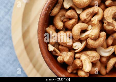 close up of cashew nuts in a bowl on table  Stock Photo