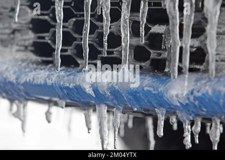 Harzgerode, Germany. 04th Dec, 2022. Icicles hang under a license plate of a parked vehicle. Frost has turned large parts of the Harz Mountains into a wintry landscape. In the coming days, it will remain frosty with isolated snow showers in the Upper Harz. Credit: Matthias Bein/dpa/Alamy Live News Stock Photo