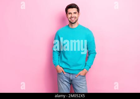 Photo of young cheerful satisfied good mood guy student wear blue sweater smiling wear stylish outfit promo isolated on pink color background Stock Photo