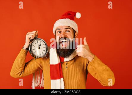 Santa Claus waits for New Year on red background. Stock Photo