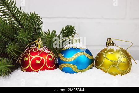 Christmas toys on a light background, in artificial snow. Selective focus Stock Photo