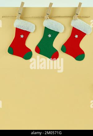 Handmade Creative Christmas greeting card with colorful socks on the rope Stock Photo