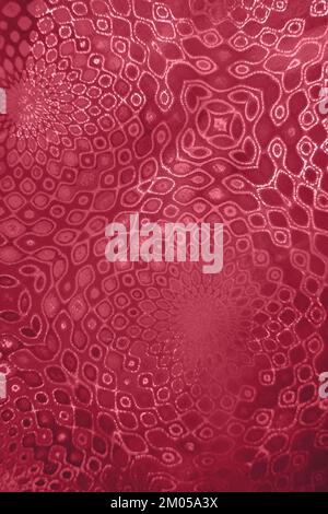 Decorative pattern on textured holographic paper. Selective focus. Trendy toning in color 2023 Viva Magenta. Vertical format. Stock Photo