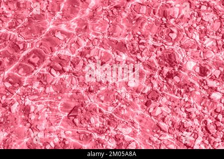 Transparent smooth water surface and bottom with small stones on the sand. Water, background, vacation concept, trendy travel advertising background. Stock Photo