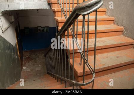 old soviet dirty dark staircase at the entrance of an apartment building in the city of dnipro in ukraine Stock Photo