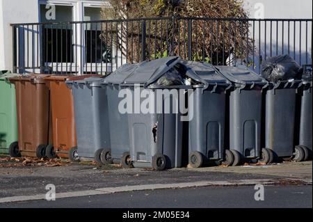 Wheelie bins in row for refuge collection outside council residential building Stock Photo