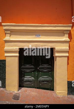 Cutted wooden door in Calle 9, La Candelaria, Bogotá, Colombia Stock Photo