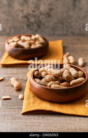 Image of bunch of peanuts in a bowl on a wooden table Stock Photo