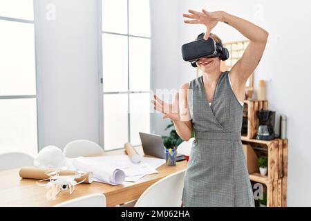 Young caucasian woman smiling confident using vr goggles working at architecture studio Stock Photo