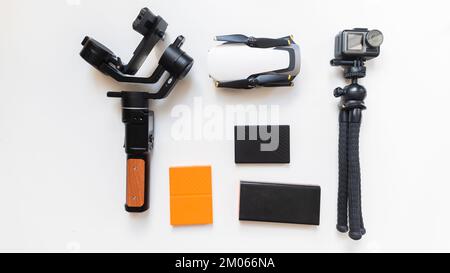 Professional video and photo equipment including action camera, hard drive drone and hard drives, power bank cut out on white isolated background Stock Photo