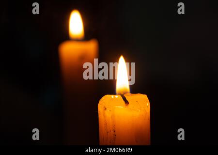 candle fire and back reflection of a candle in a mirror Stock Photo