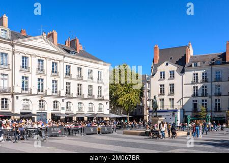 The place du Bouffay is a pedestrian square in the historic center of Nantes, France, with sidewalk cafes and the statue 'Eloge du Pas de Côté'. Stock Photo