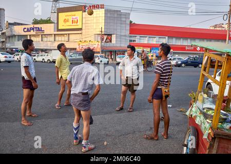 Young men playing street football in Yangon Myanmar Stock Photo