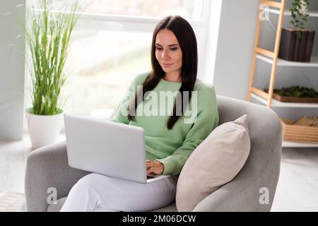 Photo of concentrated focused lady accountant sitting cozy chair use modern device netbook macbook reading cv resume room indoors Stock Photo