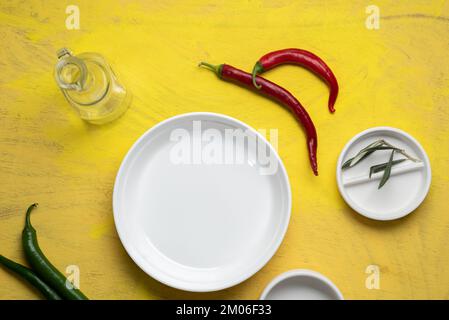 Empty white ceramic plates with red and green chili pepper  Stock Photo