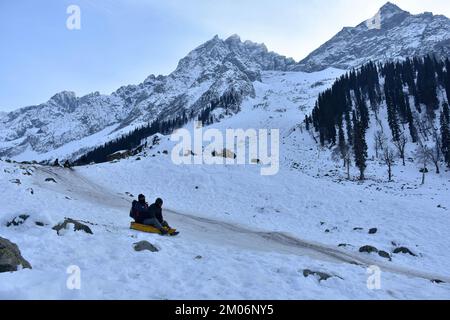 Sonamarg, India. 04th Dec, 2022. Indian tourists enjoy a sledge ride on a snow covered slope at Thajwas hill station, in Sonamarg, about 100kms northeast of Srinagar, the summer capital of Jammu and Kashmir. (Photo by Saqib Majeed/SOPA Images/Sipa USA) Credit: Sipa USA/Alamy Live News Stock Photo