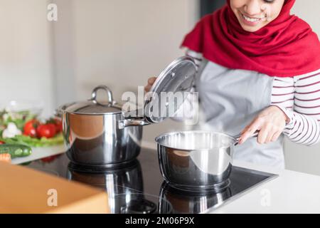Cropped of muslim housewife preparing dinner for her family Stock Photo