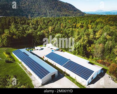 Solar panels on the roof top of a warehouse somewhere in the country side of Slovenia Stock Photo