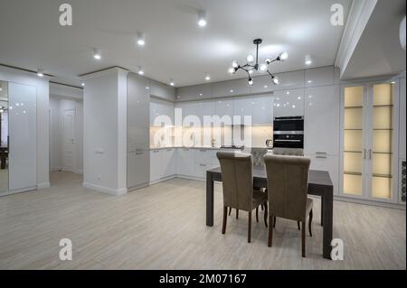 Interior of new spacious white kitchen after renovation in studio apartmen Stock Photo